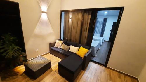 a living room with a couch and a chair at Arenal Monara in Fortuna