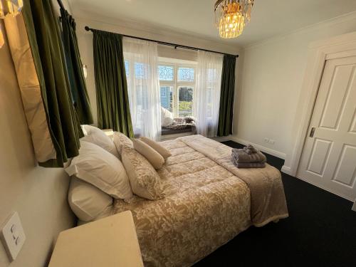 a bedroom with a bed with pillows and a window at Pinot Villas in Martinborough 