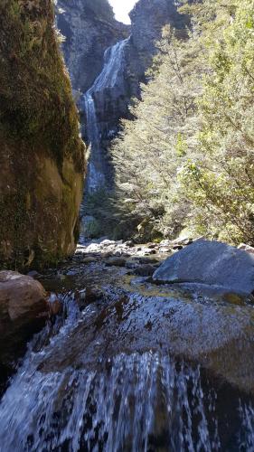 a stream of water in a canyon with a waterfall at Ruapehu Mountain Motel & Lodge in Ohakune
