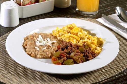 a plate of breakfast food on a table at Holiday Inn Express & Suites Monterrey Valle by IHG in Monterrey