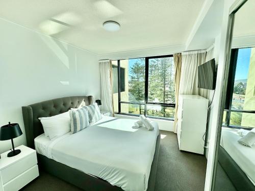 a bedroom with a bed and a large window at BB on the Park 504 in Gold Coast