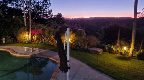 a backyard with a swimming pool at night at Healing Garden Bed & Breakfast - Ubud in Gold Coast