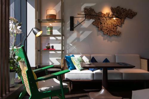 a living room with a couch and a table at Hotel Indigo Kuala Lumpur on the Park by IHG in Kuala Lumpur