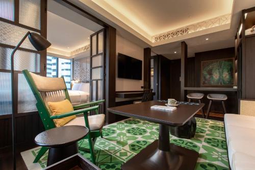 a hotel room with a table and chairs and a bed at Hotel Indigo Kuala Lumpur on the Park by IHG in Kuala Lumpur