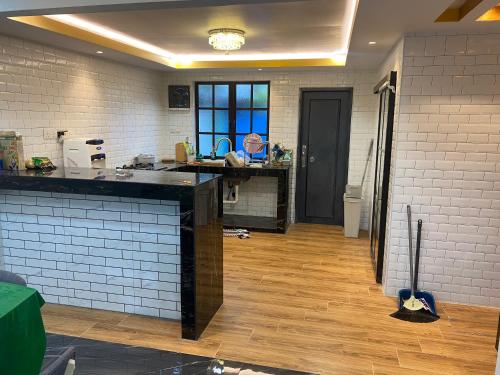 a kitchen with a counter and a counter top at Kak Ani Homestay in Pasir Gudang