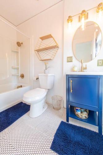a bathroom with a toilet and a sink and a mirror at Manitou Springs White Yarrow Inn House in Manitou Springs