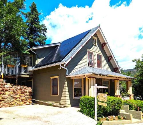 a house with solar panels on top of it at Manitou Springs White Yarrow Inn House in Manitou Springs