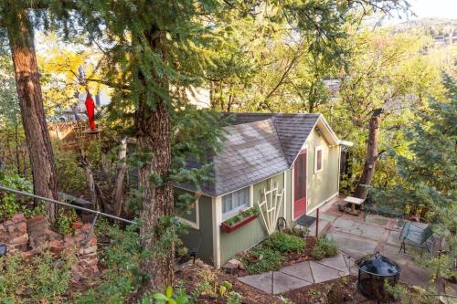a small house in the middle of the woods at Manitou Springs White Yarrow Inn House in Manitou Springs