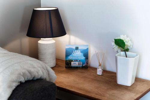 a table with a lamp and a box of dog food on it at Lake & The City in Como