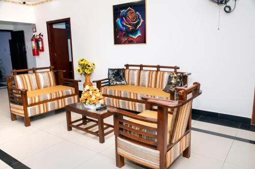 two chairs and a table in a room at Golden Star Guest House in Jaffna
