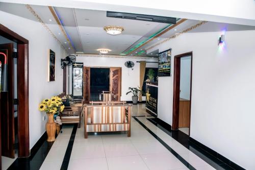 a lobby of a building with a vase of flowers at Golden Star Guest House in Jaffna