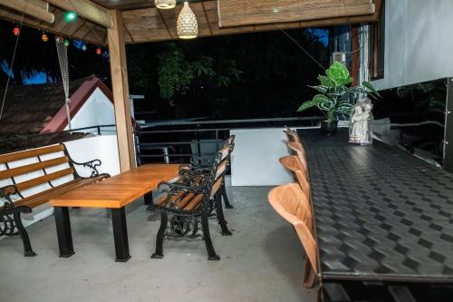 a wooden table and chairs on a patio at Golden Star Guest House in Jaffna