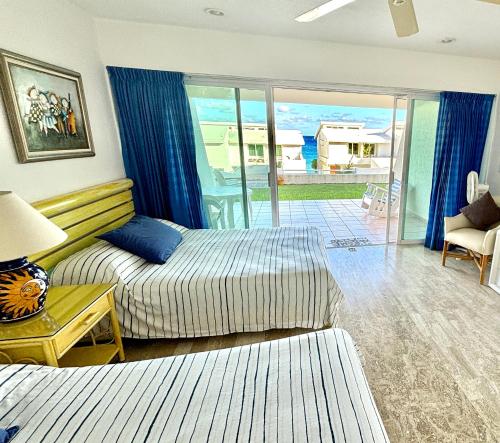 a hotel room with a bed and a balcony at Beach & Ocean Front Apartments Brisas Cancun Zona Hotelera in Cancún
