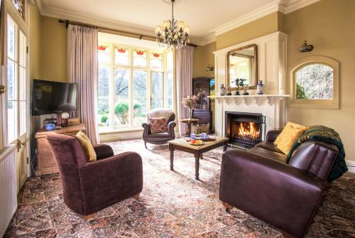 a living room with two couches and a fireplace at Sassafras village stay - historic home sleeps 4 in Sassafras