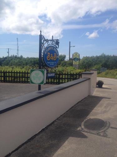 a sign for a gas station next to a fence at Atlantic House in Lisdoonvarna