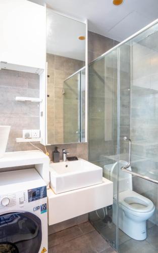 a bathroom with a sink and a toilet at H20 Residence Ara Damansara by Airhost in Petaling Jaya