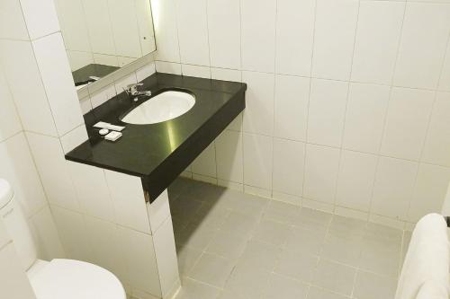a bathroom with a sink and a toilet at 1O1 URBAN Jakarta Thamrin in Jakarta
