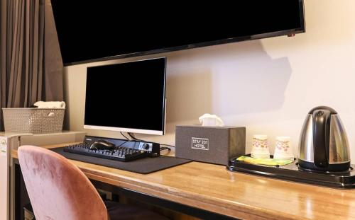 a desk with a computer monitor and a telephone on it at STAY201 in Jecheon