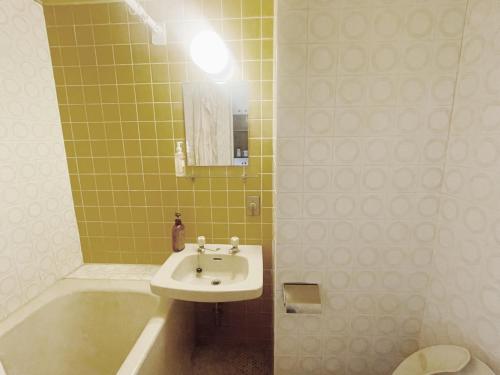 a bathroom with a sink and a tub and a toilet at Shinjuku Hana House metro 3mins in Tokyo