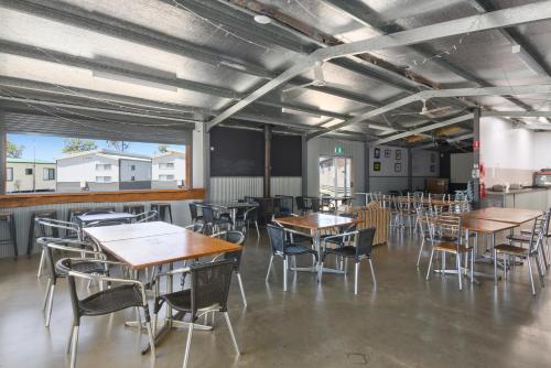 a dining room with tables and chairs in it at Ingenia Holidays Eden Beachfront in Eden