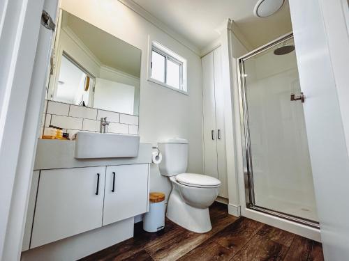 a bathroom with a toilet and a sink and a shower at Big4 Ulladulla Beachside Holiday Park in Ulladulla