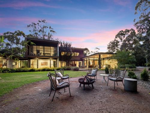 a group of chairs in front of a house at SpaceNature in Margaret River Town