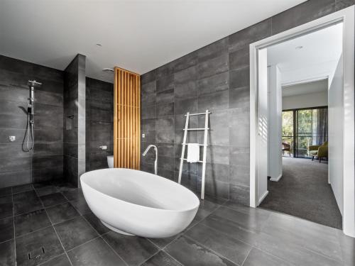 a bathroom with a large white tub in a room at SpaceNature in Margaret River Town