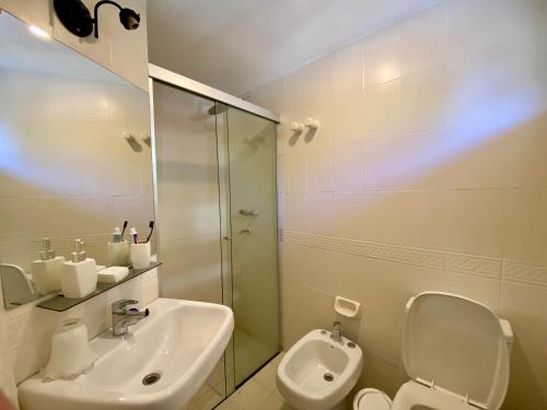a bathroom with a sink and a toilet and a shower at Hostalito Las Mercedes in Asuncion