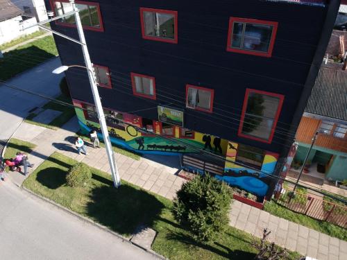 a building with a mural on the side of it at Esquina Huella Patagónica in Coihaique