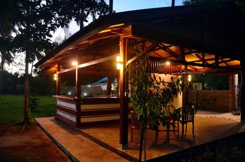 a gazebo with a table and chairs and lights at AMIGOS BUNGALOWS GILI MENO in Gili Meno