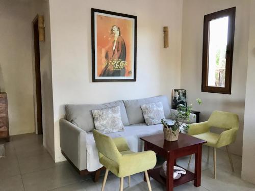 a living room with a couch and chairs and a table at CasaCalma Great for families! in Holbox Island