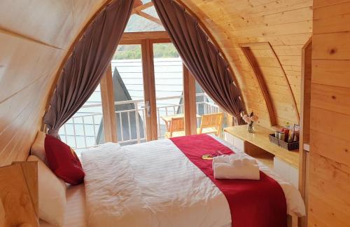 a bedroom with a bed with a large window at Sapa the chill garden &villas in Sa Pa