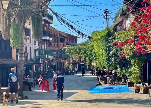 a group of people walking down a street at Himchuli Guest House in Bandīpur