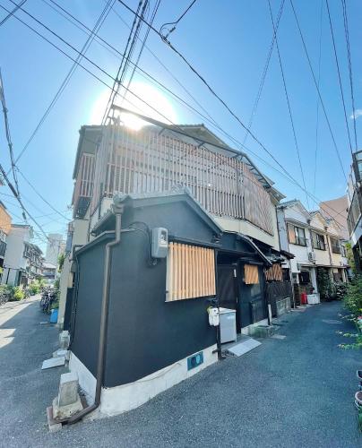 a building with a fence in front of a building at East Shin-Osaka Hotel Apartment in Osaka