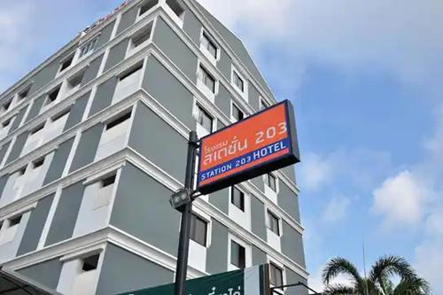 a street sign in front of a building at Station 203 Hotel in Bangkok