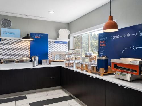 a kitchen with black cabinets and a counter at Holiday Inn Express Fort Bragg by IHG in Fort Bragg