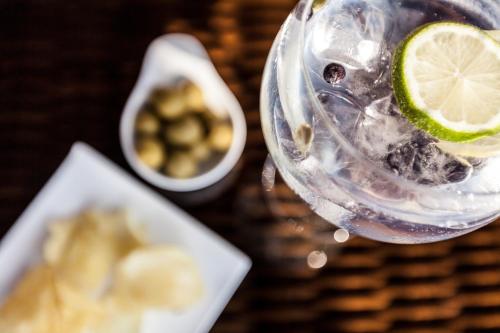 a drink with a lime in a glass on a table at Estança La Pau - Adults Only in Mallá