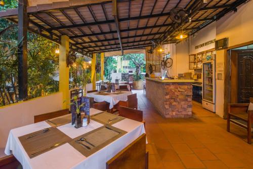 a restaurant with tables and chairs and a counter at Samnak Lounge in Siem Reap