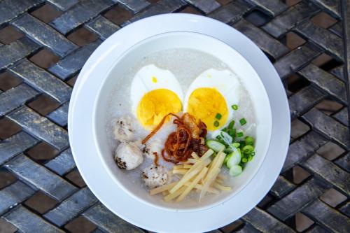 a bowl of ramen with eggs and meat and noodles at Phongsavath Boutique Hotel in Vientiane