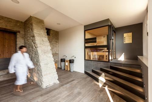 a man walks through the lobby of a house at Estança La Pau - Adults Only in Mallá