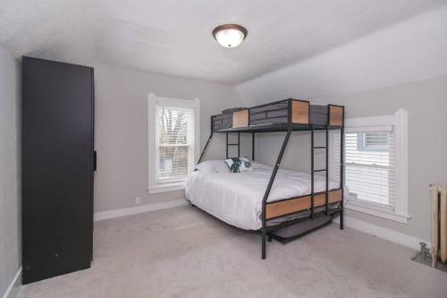 a bedroom with a bunk bed and two windows at Lakeside Home in Lorain in Lorain