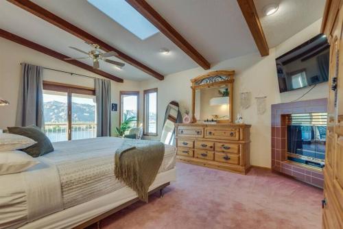 a bedroom with a large bed and a fireplace at Riverfront Gem, Spa, Games, BBQ, Pet-Friendly! in Bullhead City