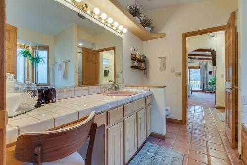 a large bathroom with a sink and a mirror at Riverfront Gem, Spa, Games, BBQ, Pet-Friendly! in Bullhead City