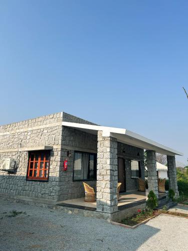 a small stone building with a large window at Jawai Empire Resort by Premier Hotels in Pāli