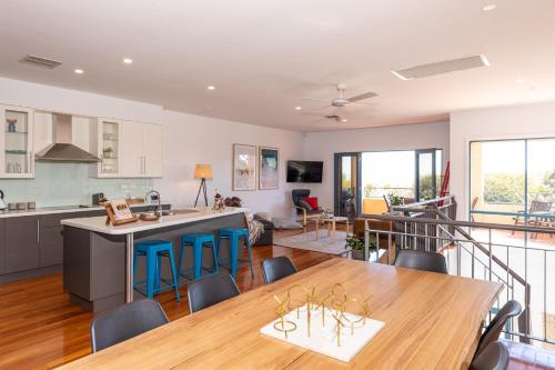 a kitchen and dining room with a table and chairs at Yarlu-Ityangka in Sellicks Beach