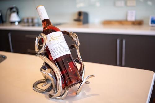 a bottle of wine in a holder on a table at Yarlu-Ityangka in Sellicks Beach