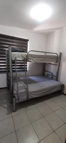 a bunk bed in the corner of a room at Casa en fraccionamiento privado in Apodaca