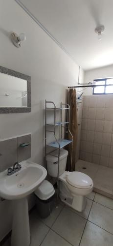 a bathroom with a toilet and a sink at Casa en fraccionamiento privado in Apodaca