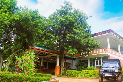 a jeep parked in front of a house at Green Hut Nature Resort in Sigiriya