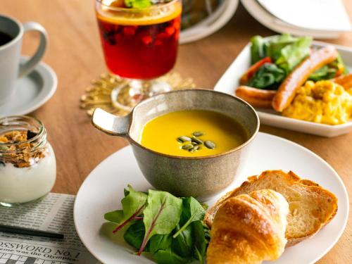 a table with a bowl of soup and a plate of food at eph KYOTO in Kyoto